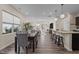 Open-concept dining area with hardwood floors and views of the kitchen and living room at 917 Matterhorn Dr, Fuquay Varina, NC 27526