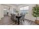 Sunlit dining room featuring hardwood floors, neutral decor, and a large window with a backyard view at 917 Matterhorn Dr, Fuquay Varina, NC 27526
