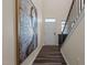 Hallway with wood floors and large art piece leads to front door and staircase at 917 Matterhorn Dr, Fuquay Varina, NC 27526