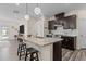Open-concept kitchen with dark cabinetry, granite countertops, stainless steel appliances, and a breakfast bar at 917 Matterhorn Dr, Fuquay Varina, NC 27526