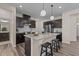 Modern kitchen featuring dark cabinetry, granite countertops, stainless steel appliances, and a central island with seating at 917 Matterhorn Dr, Fuquay Varina, NC 27526