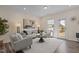 Bright living room with neutral colors, stylish furniture, hardwood floors, and a view of the backyard at 917 Matterhorn Dr, Fuquay Varina, NC 27526