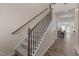 Carpeted staircase with wooden railing leads to upper level, showcasing modern design at 917 Matterhorn Dr, Fuquay Varina, NC 27526