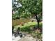 Landscaped backyard featuring a wood fence, mature trees, and patio furniture at 917 Widewaters Pkwy, Knightdale, NC 27545