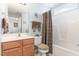 Bathroom with wood vanity, toilet, tub and shower combination at 917 Widewaters Pkwy, Knightdale, NC 27545