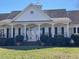 Beautiful clubhouse with black shutters, elegant columns and meticulously landscaped shrubbery at 917 Widewaters Pkwy, Knightdale, NC 27545