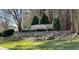 Stone entrance sign for Widewaters Village community, surrounded by lush greenery and landscaping at 917 Widewaters Pkwy, Knightdale, NC 27545