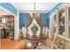 Formal dining room with elegant chandelier, wood floors, and decorative window treatments at 917 Widewaters Pkwy, Knightdale, NC 27545