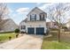 Two-story home features a two-car garage, blue shutters, and a well-manicured lawn at 917 Widewaters Pkwy, Knightdale, NC 27545