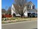 Charming two-story home featuring an attached garage, well-kept lawn, and budding trees at 917 Widewaters Pkwy, Knightdale, NC 27545