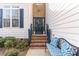 Charming front door with brick steps, decorated with a wreath and a decorative bench at 917 Widewaters Pkwy, Knightdale, NC 27545