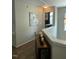 Hallway with hardwood floors, decorative console table, and view of the adjacent bedroom at 917 Widewaters Pkwy, Knightdale, NC 27545