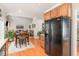 Open-concept kitchen flows into the dining area with hardwood floors and a black refrigerator at 917 Widewaters Pkwy, Knightdale, NC 27545