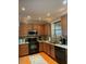 Well-lit kitchen with granite countertops, wooden cabinets, and modern appliances at 917 Widewaters Pkwy, Knightdale, NC 27545
