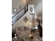Inviting living area beneath an ornate staircase, complemented by elegant decorations and cozy seating at 917 Widewaters Pkwy, Knightdale, NC 27545