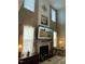 Spacious living room with tall windows, fireplace, and mounted TV at 917 Widewaters Pkwy, Knightdale, NC 27545