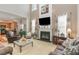 Bright living room featuring a cozy fireplace and comfortable seating arrangements at 917 Widewaters Pkwy, Knightdale, NC 27545