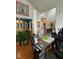 Bright office with a large desk, hardwood floors, and adjacent dining area at 917 Widewaters Pkwy, Knightdale, NC 27545