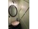Chic powder room with a vessel sink, modern lighting, and decorative wall paneling at 917 Widewaters Pkwy, Knightdale, NC 27545
