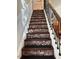 The staircase is a showcase of detailed craftsmanship, featuring decorative treads and a wrought iron railing at 917 Widewaters Pkwy, Knightdale, NC 27545