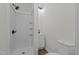 Bathroom features a white shower stall with seat, white vanity, sink, and modern black hardware at 1034 Maple St, Henderson, NC 27536