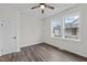 Bright bedroom featuring a large window, ceiling fan, and fresh white paint at 1034 Maple St, Henderson, NC 27536