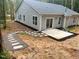 Backyard featuring a stone walkway leading to a concrete patio, and a gray exterior at 107 Cochise Dr, Louisburg, NC 27549