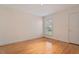 Bedroom with neutral walls, hardwood floors, and bright window at 107 Helmsdale Dr, Chapel Hill, NC 27517