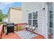 Cozy back deck with grill and comfortable seating, perfect for relaxing outdoors at 1106 Bellenden Dr, Durham, NC 27713