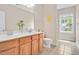 Bright bathroom features a double vanity, toilet and a window over looking yard at 1106 Bellenden Dr, Durham, NC 27713