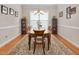 Elegant dining room with hardwood floors, ample seating, classic decor, and natural light from a large window at 1106 Bellenden Dr, Durham, NC 27713