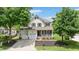 Charming two-story home with green shutters, front porch, two-car garage, and well-manicured landscaping at 1106 Bellenden Dr, Durham, NC 27713