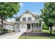 Inviting two-story home with a covered front porch, green shutters, and attached two-car garage at 1106 Bellenden Dr, Durham, NC 27713