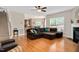 Spacious living room featuring hardwood floors, a fireplace, and a large sectional sofa at 1106 Bellenden Dr, Durham, NC 27713