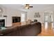 Cozy living room with hardwood floors, comfortable seating, a fireplace, and an open archway to the dining room at 1106 Bellenden Dr, Durham, NC 27713