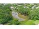 Scenic aerial view of the pond surrounded by lush greenery and trees in the community at 1106 Bellenden Dr, Durham, NC 27713