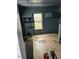 A room with blue walls, a window, and damaged flooring needing renovation at 116 Dunstan Ave, Durham, NC 27707