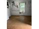 A room needing renovation, featuring graffiti, damaged walls, and stained floors at 116 Dunstan Ave, Durham, NC 27707