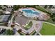 Overhead shot of community's pool, clubhouse, tennis court, outdoor seating, and landscaped grounds at 130 W Crescent Mills Blvd # Homesite 251, Wilson's Mills, NC 27520