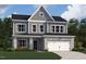 Charming two-story home with stone accents, gray siding, and a two-car garage at 130 W Crescent Mills Blvd # Homesite 251, Wilson's Mills, NC 27520