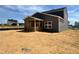 Rear exterior view displays an enclosed porch of a gray two-story home in a new construction neighborhood at 130 W Crescent Mills Blvd # Homesite 251, Wilson's Mills, NC 27520