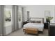 Bright bedroom with bedside tables, lamps and bench at end of the bed, and large window at 130 W Crescent Mills Blvd # Homesite 251, Wilson's Mills, NC 27520