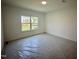 Neutral bedroom with new carpeting and a large window showcasing backyard at 130 W Crescent Mills Blvd # Homesite 251, Wilson's Mills, NC 27520