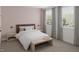 Light filled bedroom features two large windows, stylish wood furniture, and neutral colored carpet at 130 W Crescent Mills Blvd # Homesite 251, Wilson's Mills, NC 27520