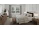 Bright bedroom with a large window, decorative pillows, and stylish wooden furniture at 130 W Crescent Mills Blvd # Homesite 251, Wilson's Mills, NC 27520