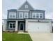 Charming two-story home with gray siding, stone accents, a two-car garage and a well-manicured lawn at 130 W Crescent Mills Blvd # Homesite 251, Wilson's Mills, NC 27520