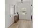 Bright foyer with wood-look flooring, white walls, and a charming console table at 130 W Crescent Mills Blvd # Homesite 251, Wilson's Mills, NC 27520