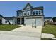 Beautiful two-story home featuring a modern color scheme, stone accents and a wide driveway at 130 W Crescent Mills Blvd # Homesite 251, Wilson's Mills, NC 27520