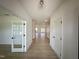 Bright hallway with wood floors, leading to an open floorplan with a kitchen and living room area at 130 W Crescent Mills Blvd # Homesite 251, Wilson's Mills, NC 27520