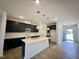 Modern kitchen with black cabinets, a white quartz countertop island and stainless steel appliances at 130 W Crescent Mills Blvd # Homesite 251, Wilson's Mills, NC 27520